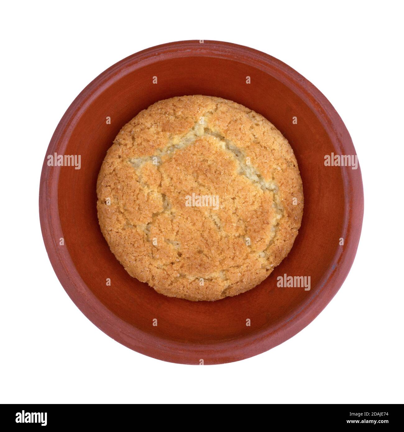 Single coconut flavor cookie on a small dish isolated on a white background. Stock Photo