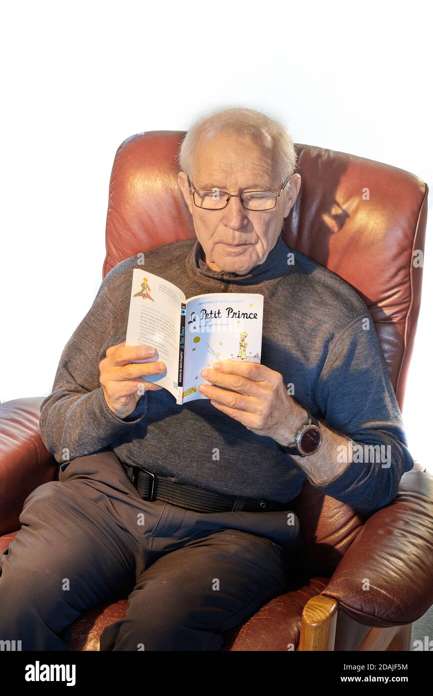 Senior male sitting on a recliner in his undershirt in boxers