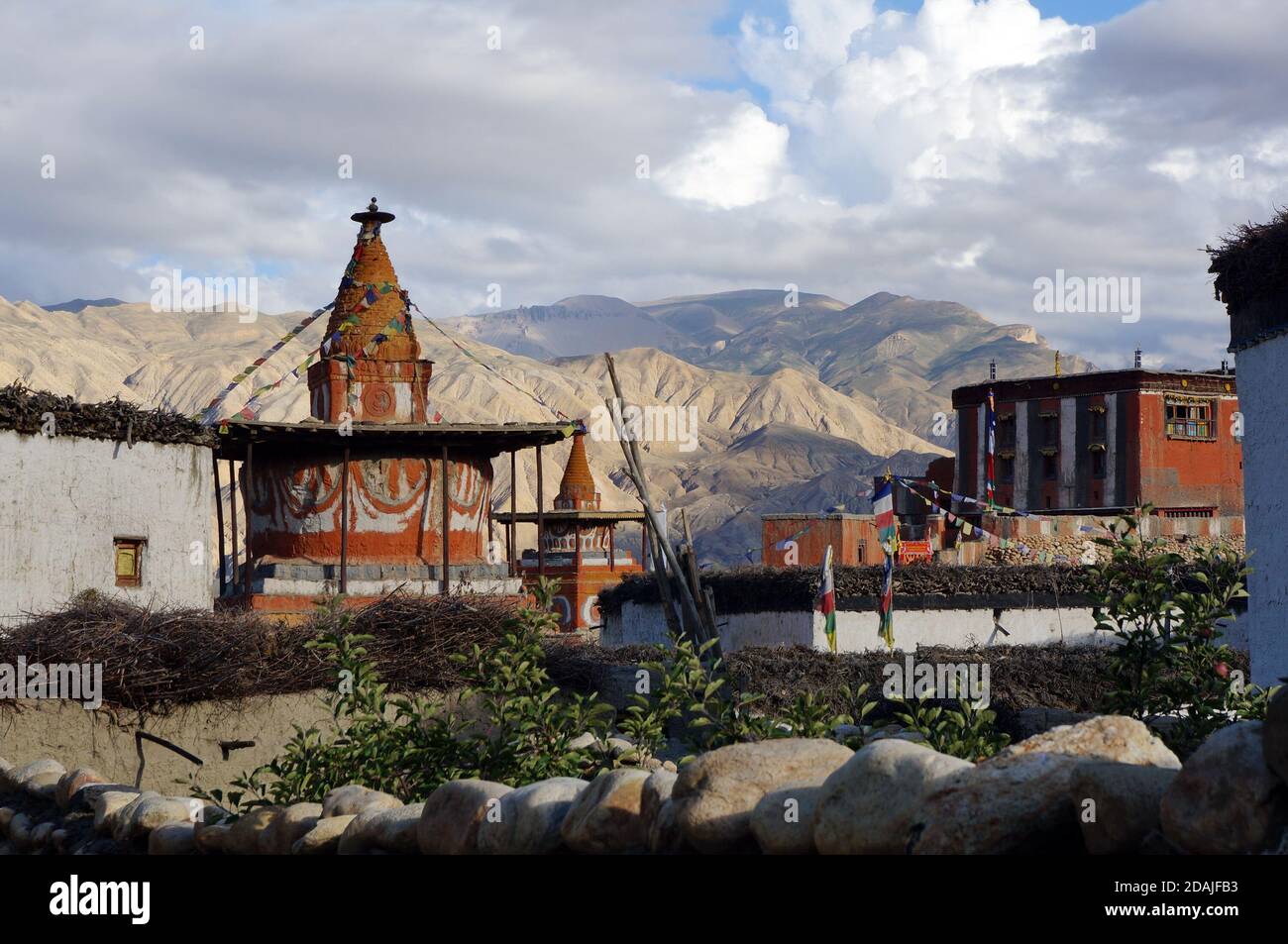View of the colorful chorten and the Buddhist monastery in the Tsarang village. Trekking to the closed zone of Upper Mustang. Nepal. Stock Photo