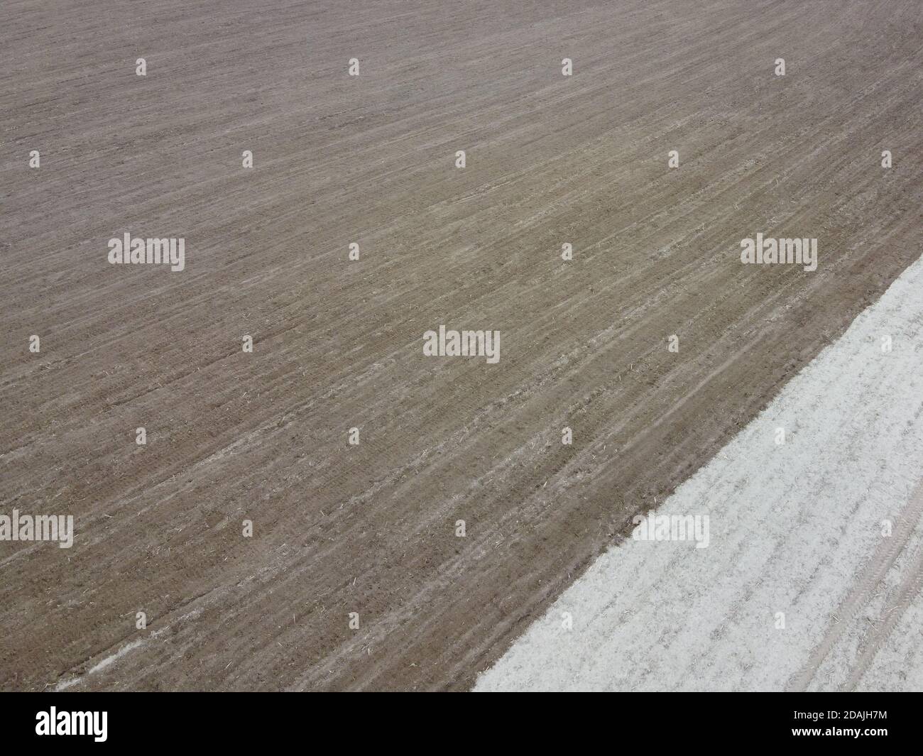 Partially plowed agricultural field, aerial view. Agricultural field, arable land. Background. Stock Photo