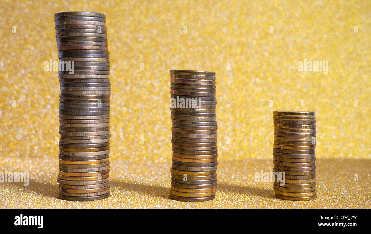 Stacks of coins on gold background Stock Photo - Alamy
