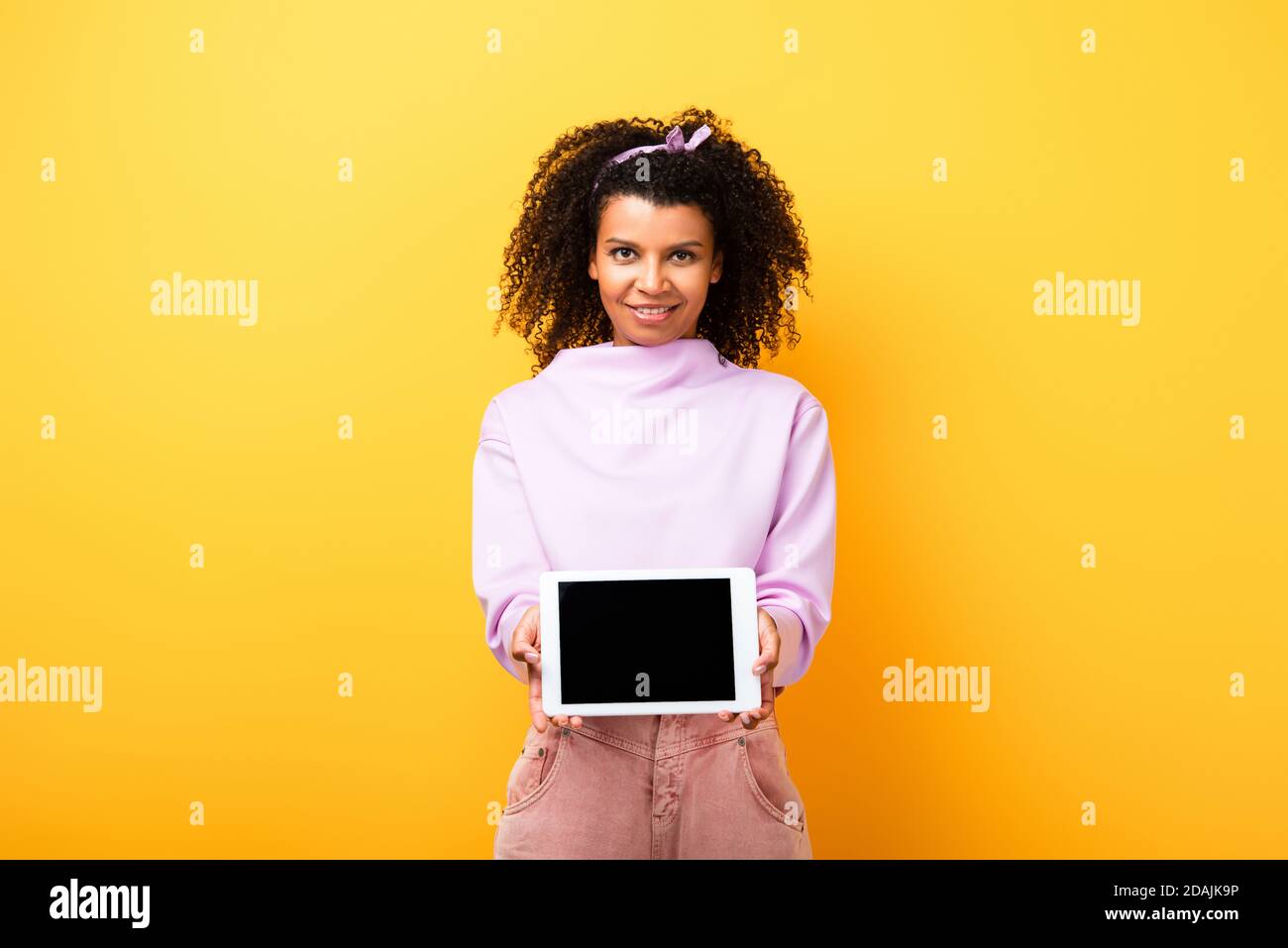 happy african american woman holding digital tablet with blank screen ...