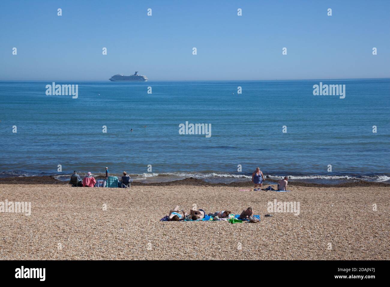 People relaxing on Overcombe Beach in Dorset in the UK, taken on the 3rd of August 2020 Stock Photo