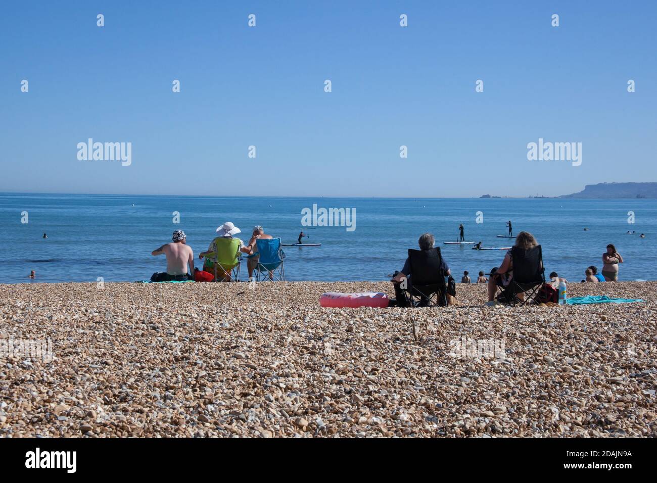 Sunbathers on Overcombe Beach in Dorset in the UK, taken on the 3rd of August 2020 Stock Photo