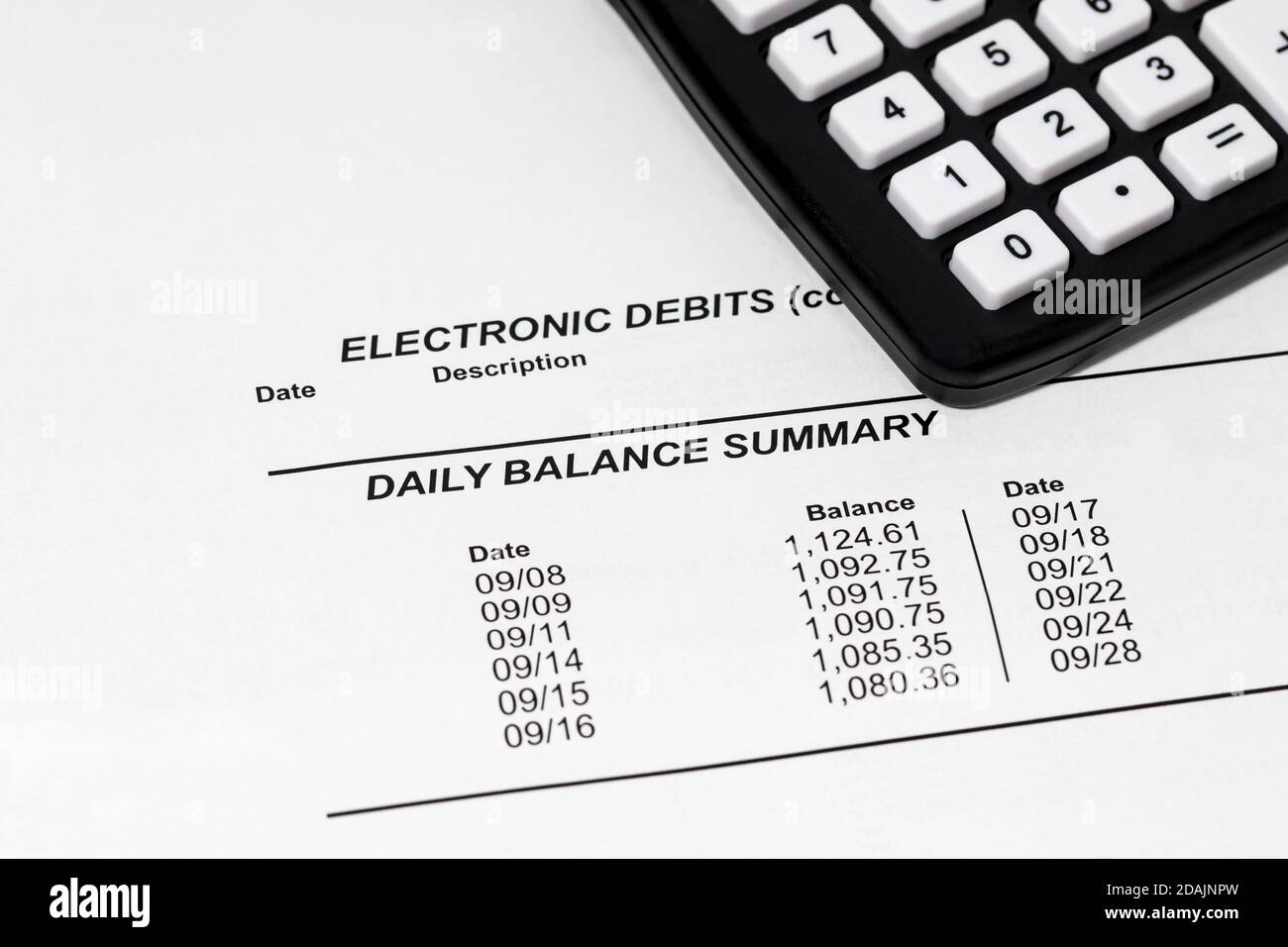 Closeup of bank statement for checking account and calculator. Concept of wealth, debt and money problems Stock Photo