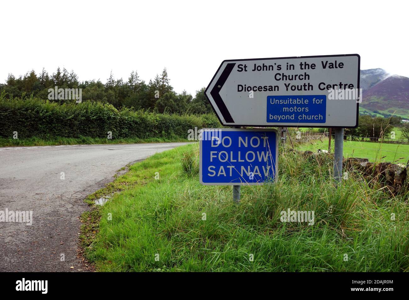 (DO NOT FOLLOW SAT NAV) on Metal Road Sign near B5322 for St John's in the Vale Church & Youth Centre in the Lake District National Park, Cumbria. Stock Photo