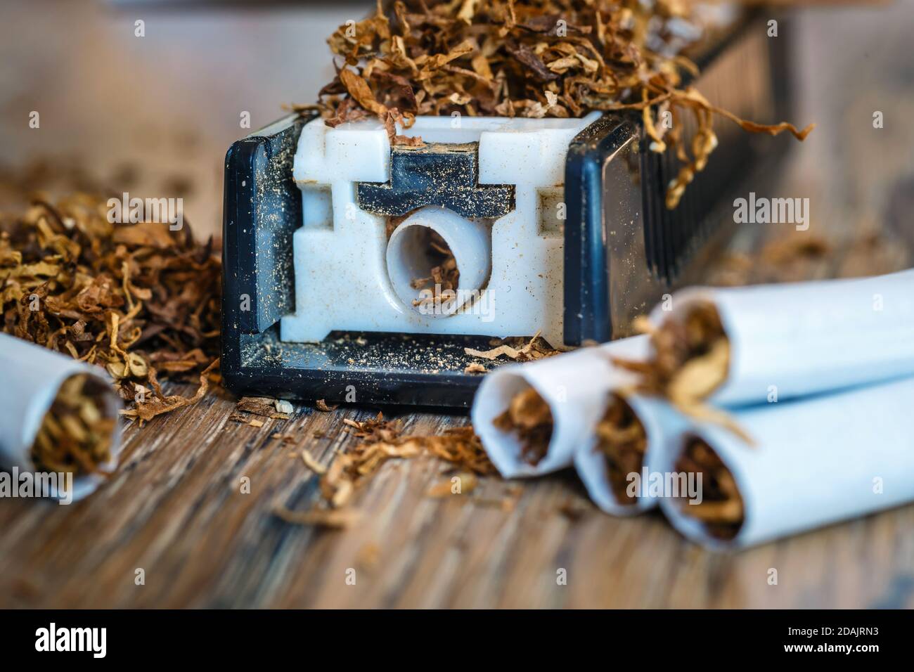 hand-made cigarettes at home using a manual machine Stock Photo - Alamy
