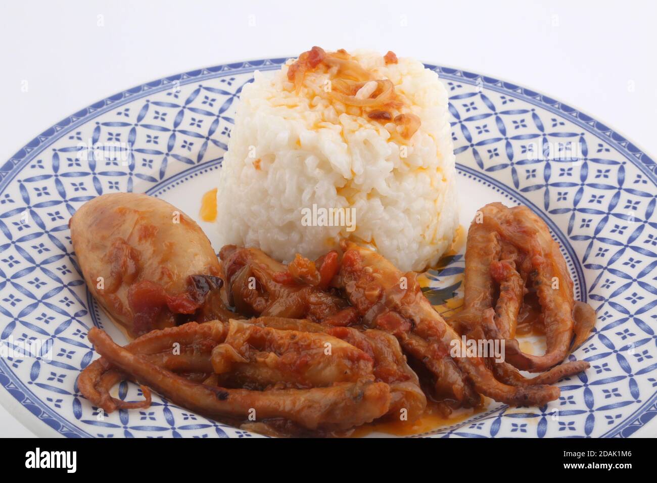 octopus cooked with onions and white rice side Stock Photo - Alamy