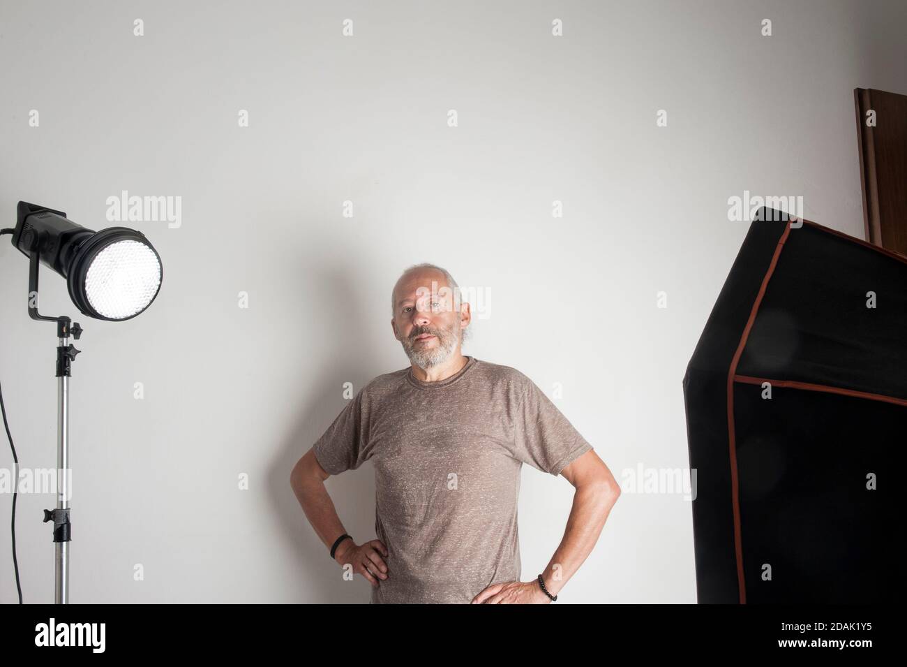 Self-employed senior photographer without digital camera in his photo studio Stock Photo