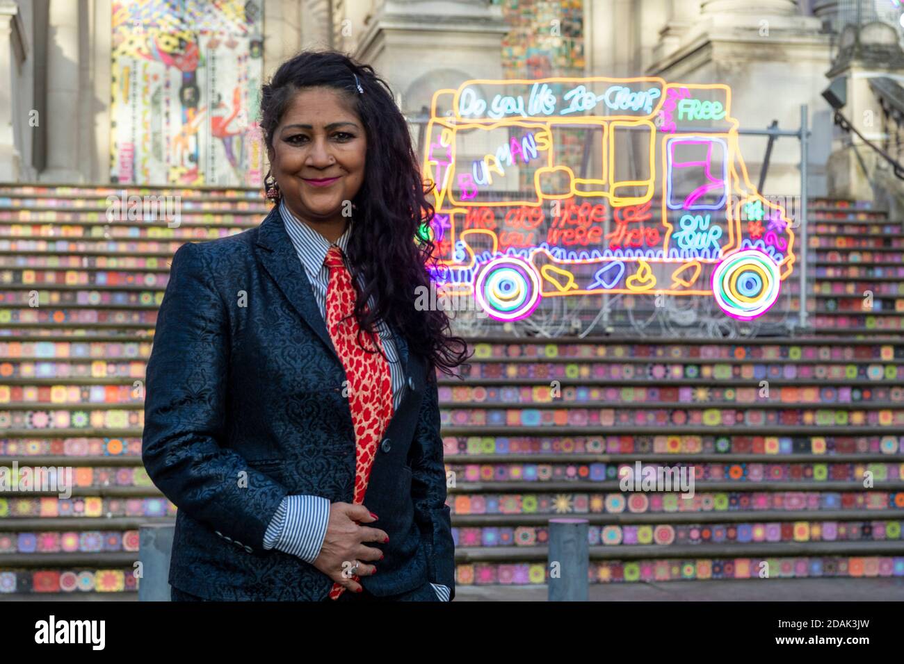 London, Britain. 13th Nov, 2020. Artist Chila Kumari Singh Burman poses for a photo in front of her art installation created for Tate Britain's annual Winter Commission at Tate Britain in London, Britain, Nov. 13, 2020. Chila Kumari Singh Burman created a technicolour installation for Tate Britain's iconic facade. This is the fourth in Tate Britain's series of outdoor commissions to mark the winter season. Credit: Ray Tang/Xinhua/Alamy Live News Stock Photo