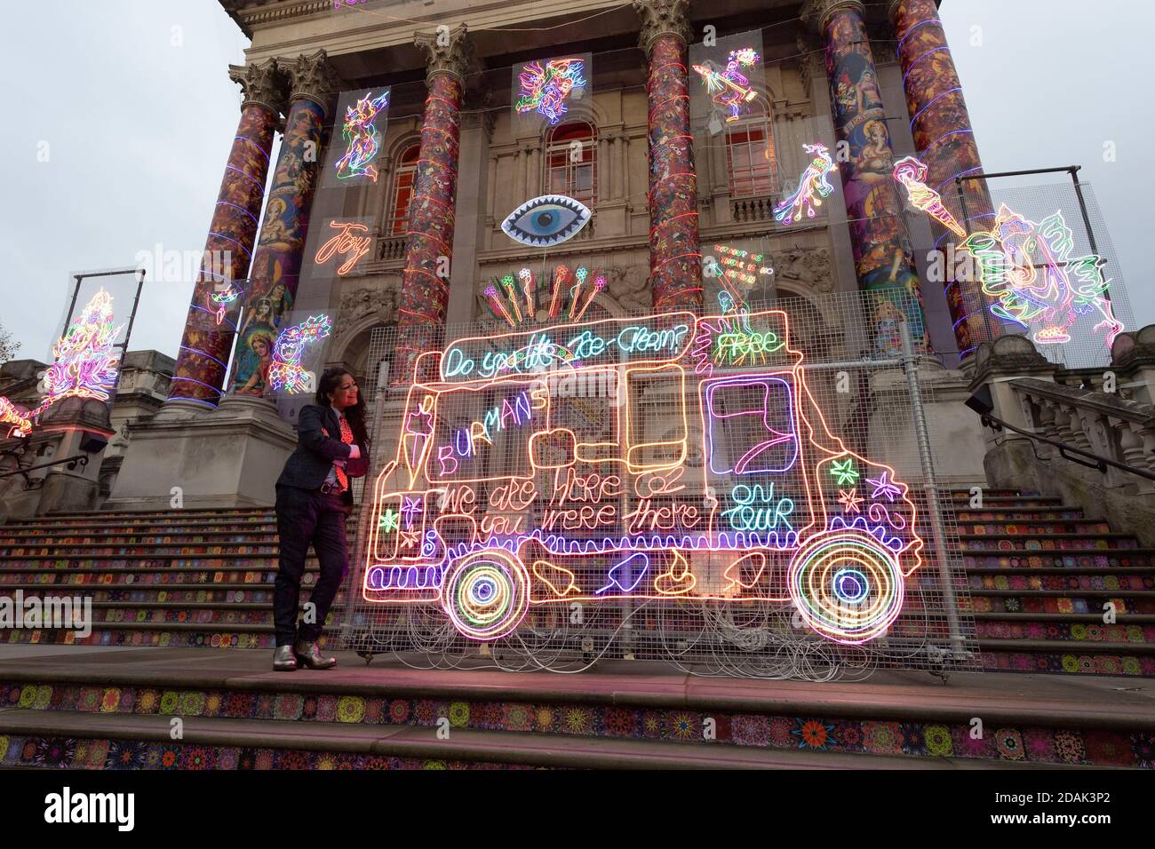 London, Britain. 13th Nov, 2020. Artist Chila Kumari Singh Burman poses for a photo with her art installations created for Tate Britain's annual Winter Commission at Tate Britain in London, Britain, Nov. 13, 2020. Chila Kumari Singh Burman created a technicolour installation for Tate Britain's iconic facade. This is the fourth in Tate Britain's series of outdoor commissions to mark the winter season. Credit: Ray Tang/Xinhua/Alamy Live News Stock Photo