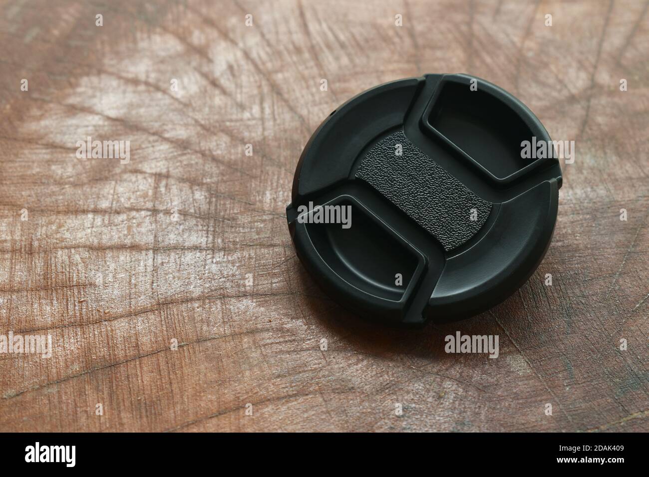 black camera lens cap for protection on wooden board Stock Photo Alamy