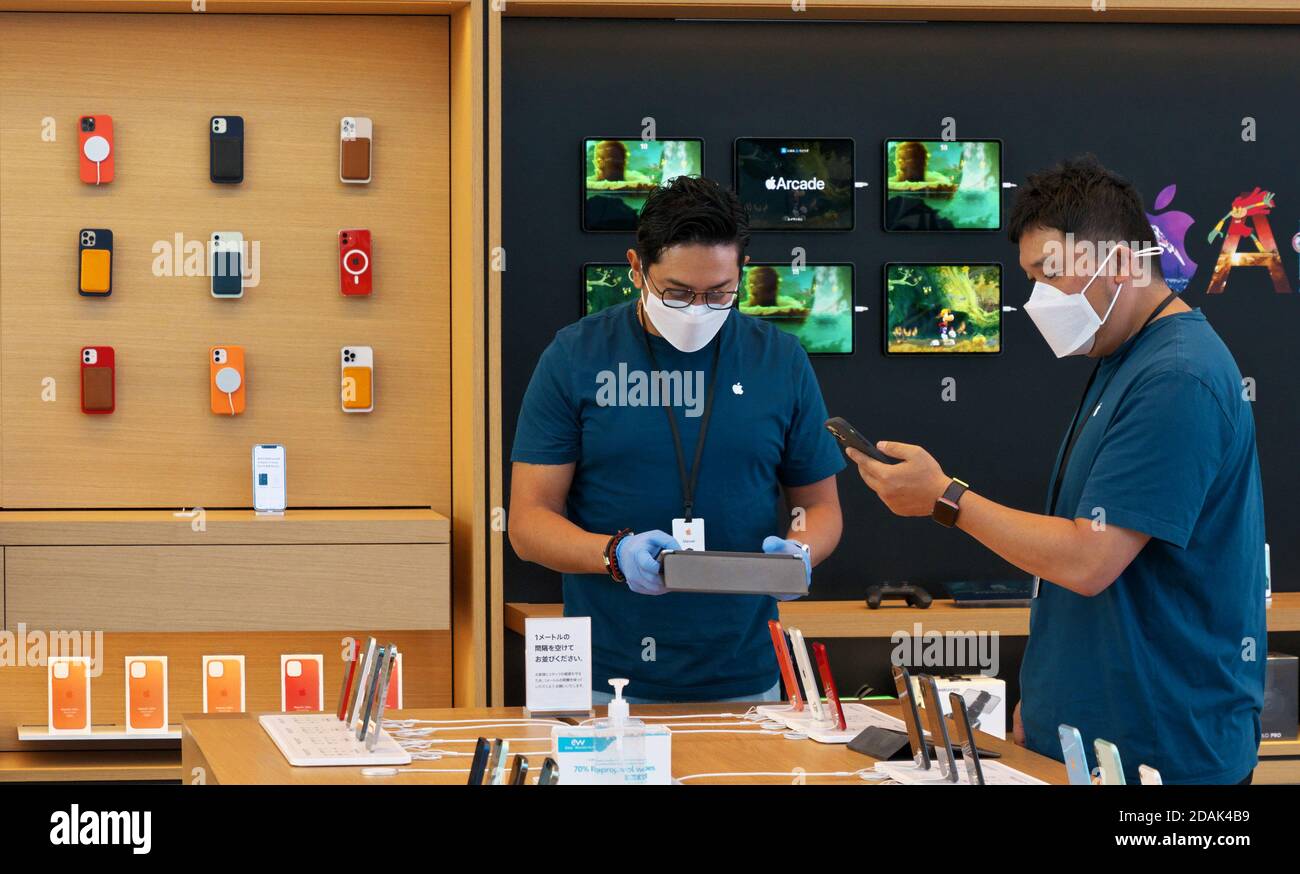 Employees of Apple are seen checking a products during the launch day for iPhone 12 mini and 12 Pro Max smartphones at Apple Omotesando store in Tokyo, Japan on Friday, November 13, 2020.     Photo by Keizo Mori/UPI Stock Photo