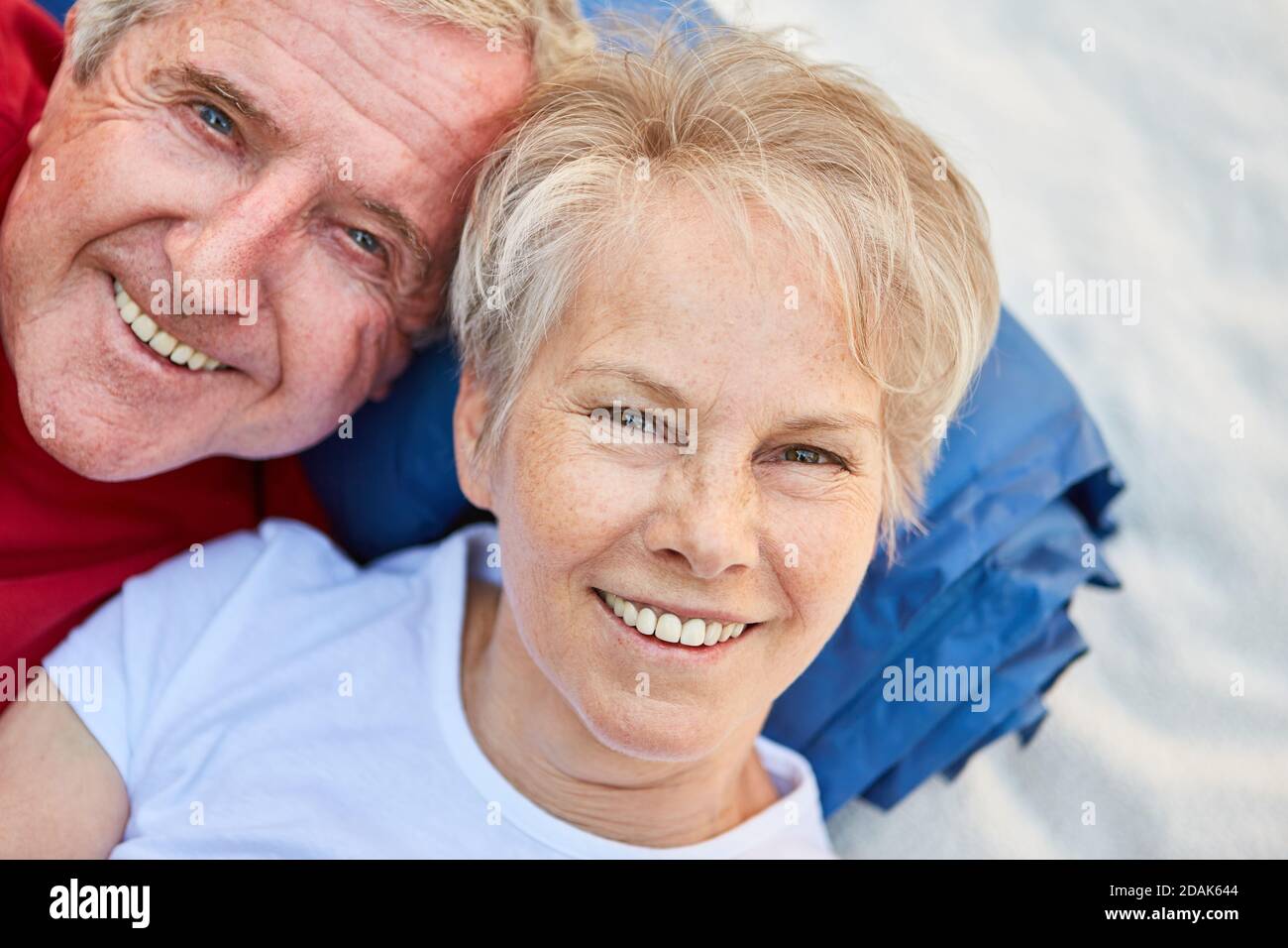Happy senior couple as retirees on outdoor vacation while camping in nature Stock Photo