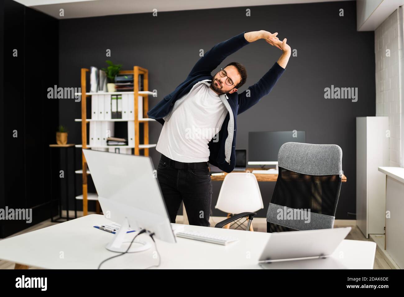 Exercise Stretch Standing Near Office Business Desk Stock Photo