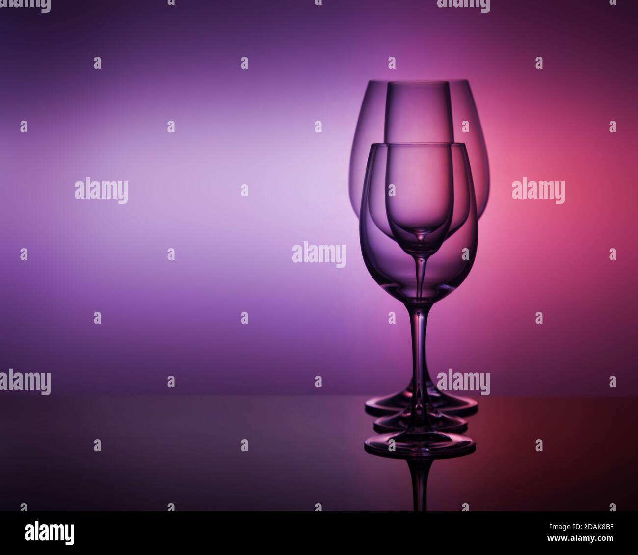 close-Up view Of various empty Glasses Against Colored Background Stock Photo