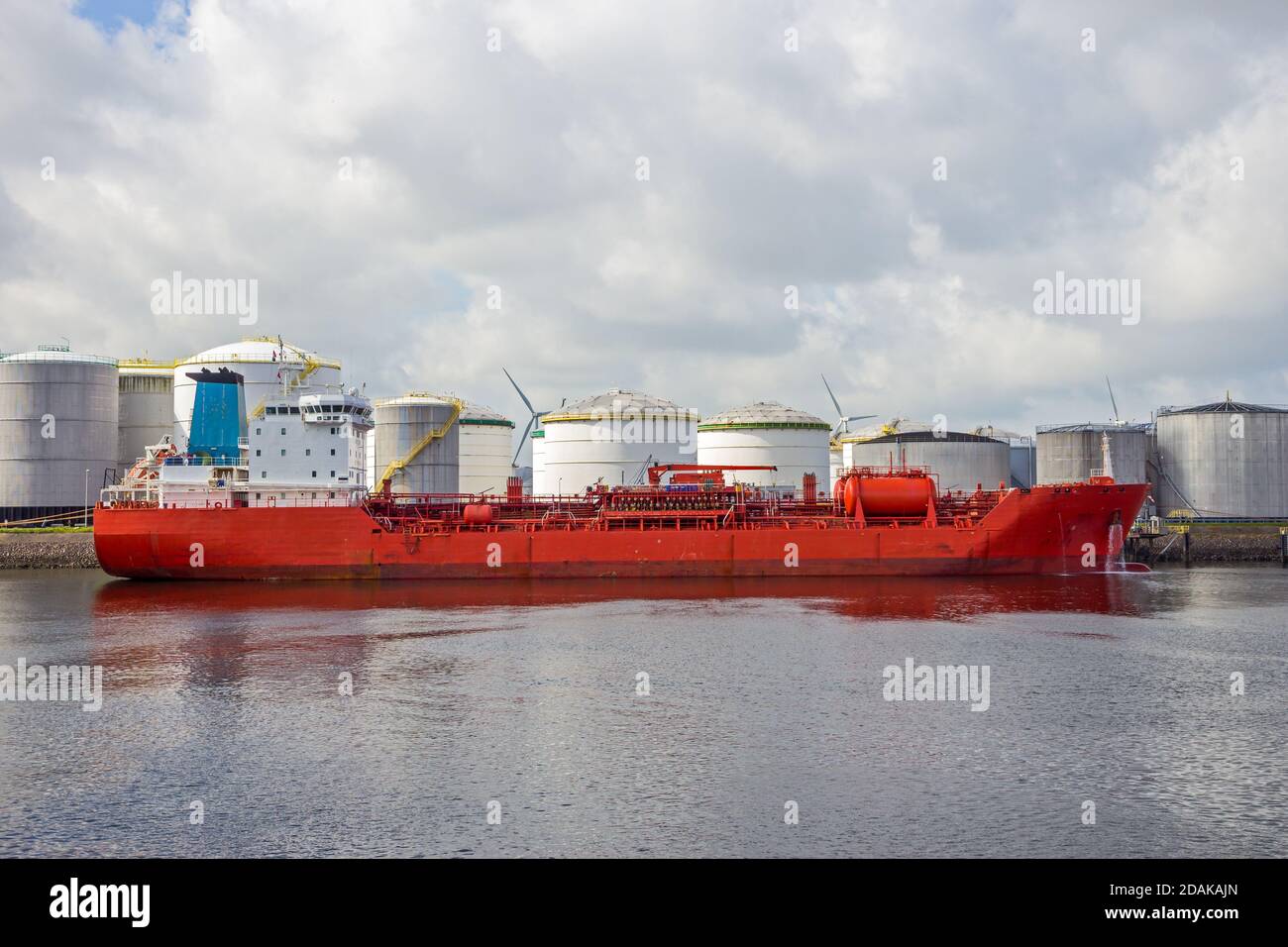Red oil tanker moored at an silo's at an oil terminal in the Port of Rotterdam Stock Photo