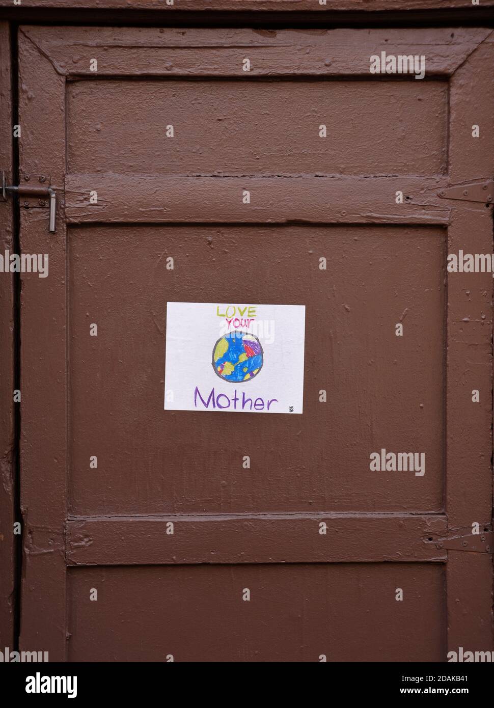 A child's drawing of Mother Earth affixed to a door in downtown Santa Fe, New Mexico USA. Stock Photo