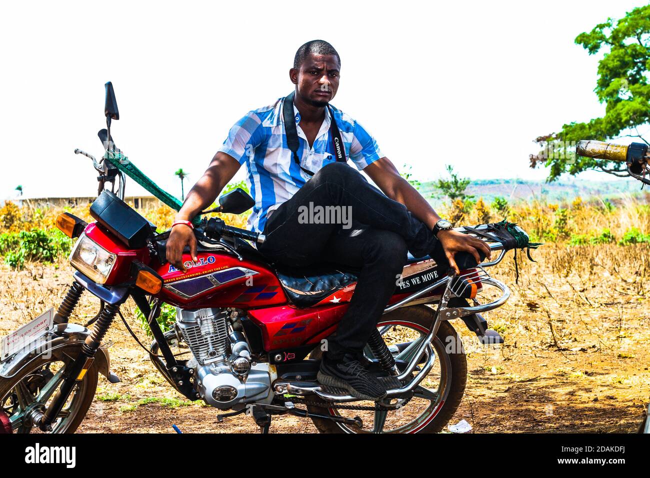 A man seated on his motor bike. Sierra Leone Stock Photo - Alamy