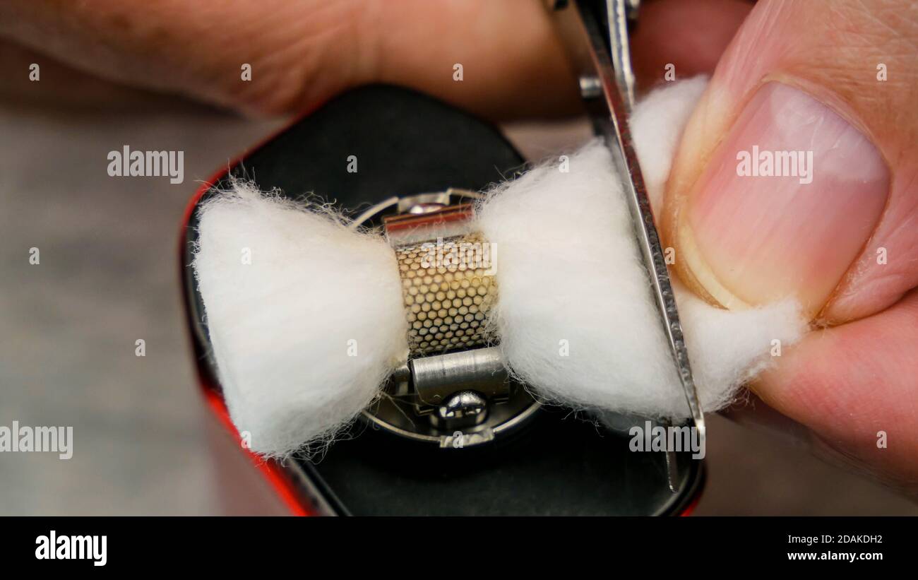 Preparation of mesh coil in the atomizer for vaping Cutting ends of the cotton under the coil