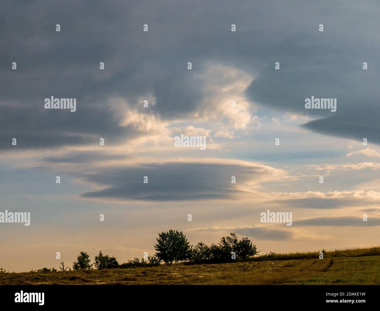 Lenticular cloud - Altocumulus lenticularis - strange cloud in the shape of a UFO in the sky Stock Photo