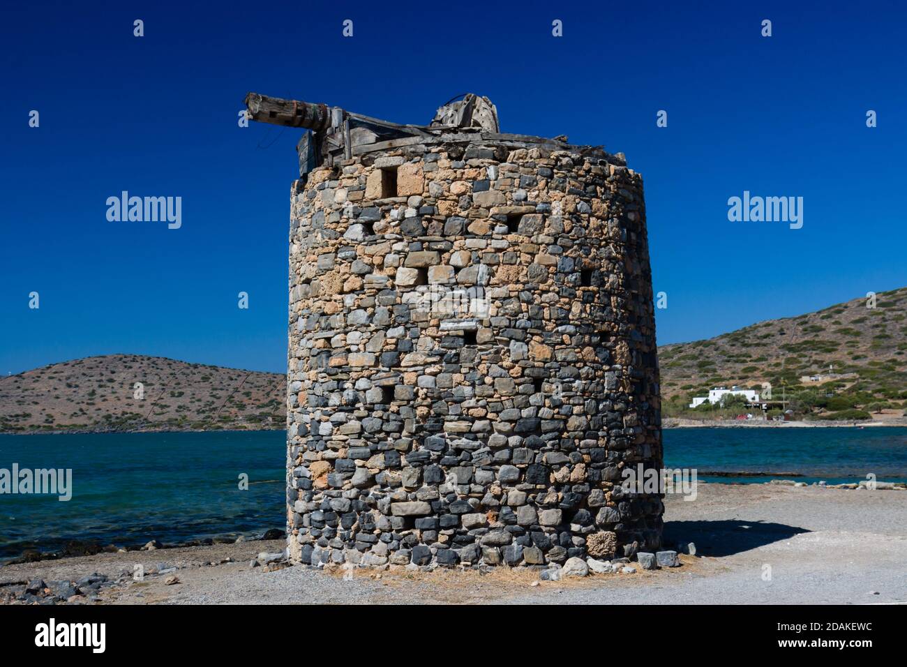 Remains of old, stone windmills on the Kolokitha peninsula near the town of Elounda, Crete Stock Photo