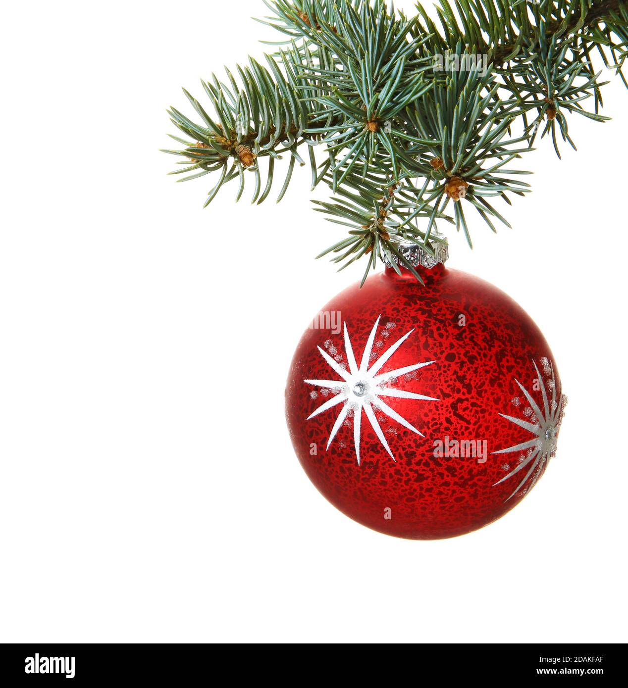 Christmas decoration isolated on the white background. Christmas ball on spruce tree branch. Stock Photo