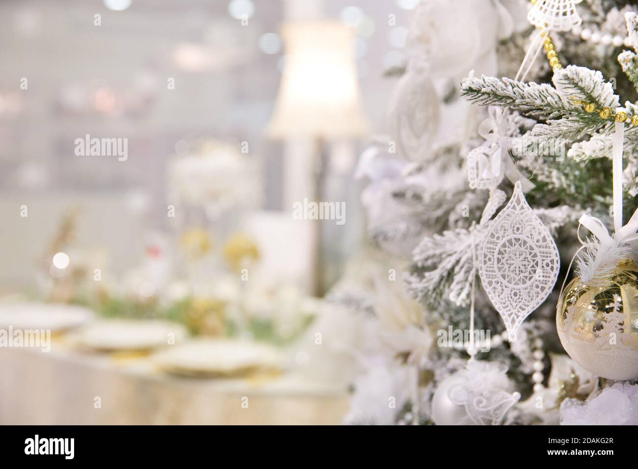 Christmas or New Year card. New Year's decor in white colors. Christmas decorations on the fir. Stock Photo