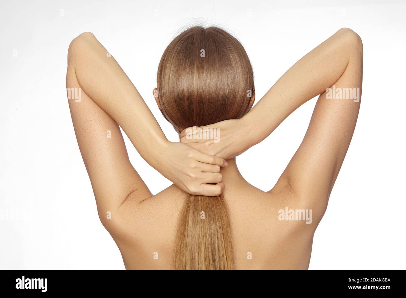 Healthy Shiny Long Hair in Tale. Beautiful Girl holding her Hair in hand.  Back view on white. Smooth Hairstyle with strong Hair Stock Photo - Alamy