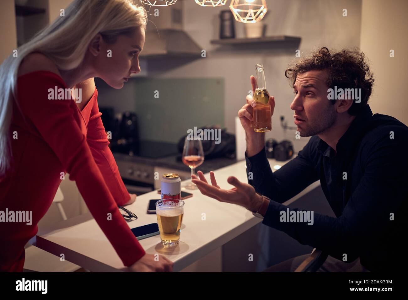 angry caucasian  wife arguing with her drunk husband Stock Photo
