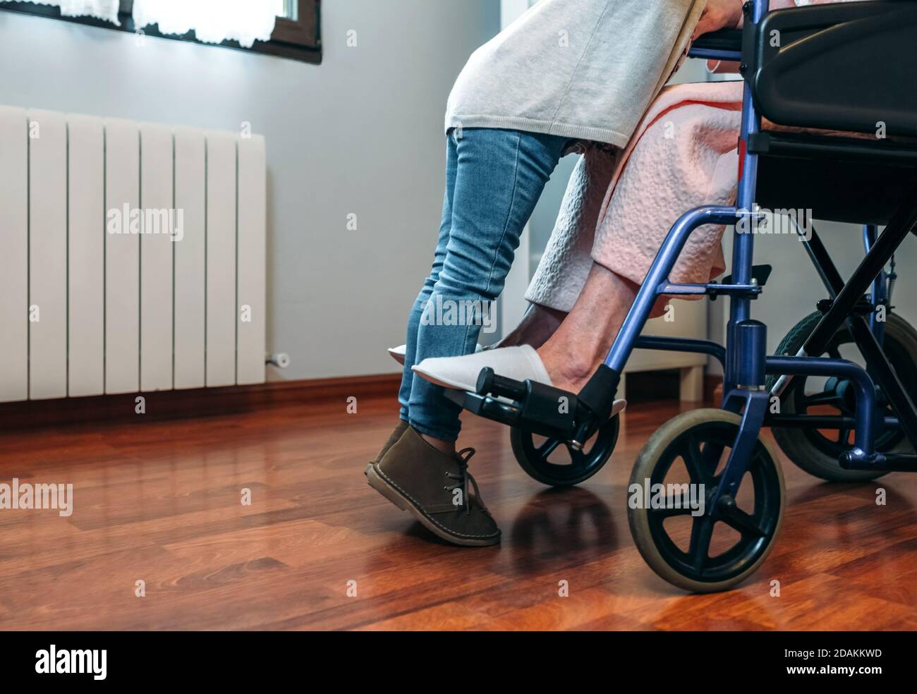 Granddaughter visiting her grandmother in wheelchair Stock Photo