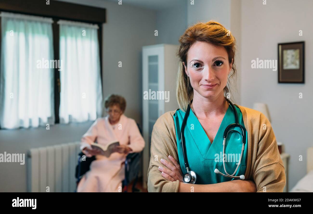 Pretty female doctor posing in a geriatric clinic Stock Photo