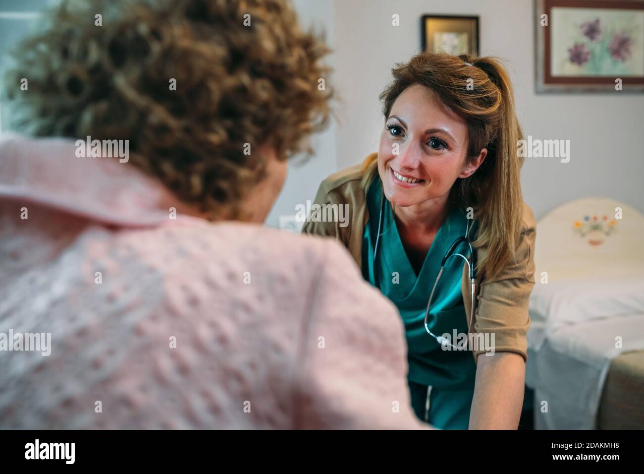 Doctor talking to elderly patient in a wheelchair Stock Photo