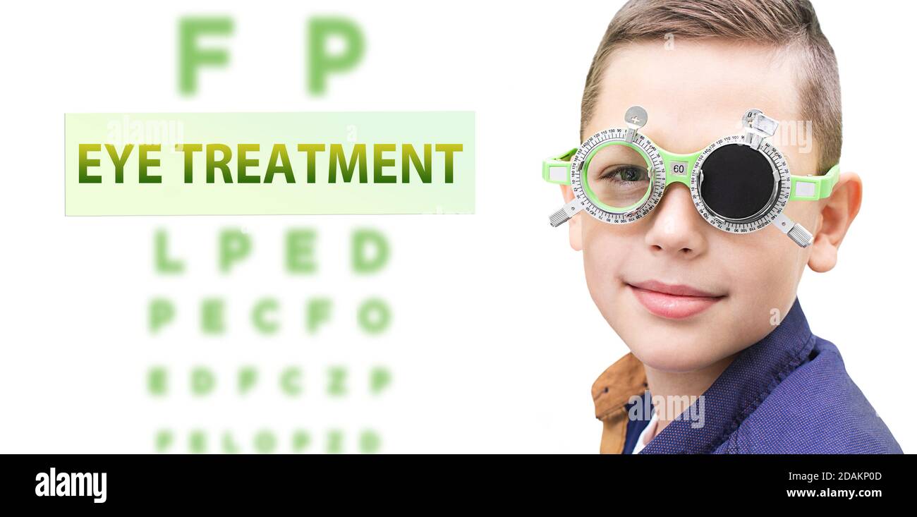 Child eye treatment. Boy while vision treatment, wearing special glasses. Stock Photo