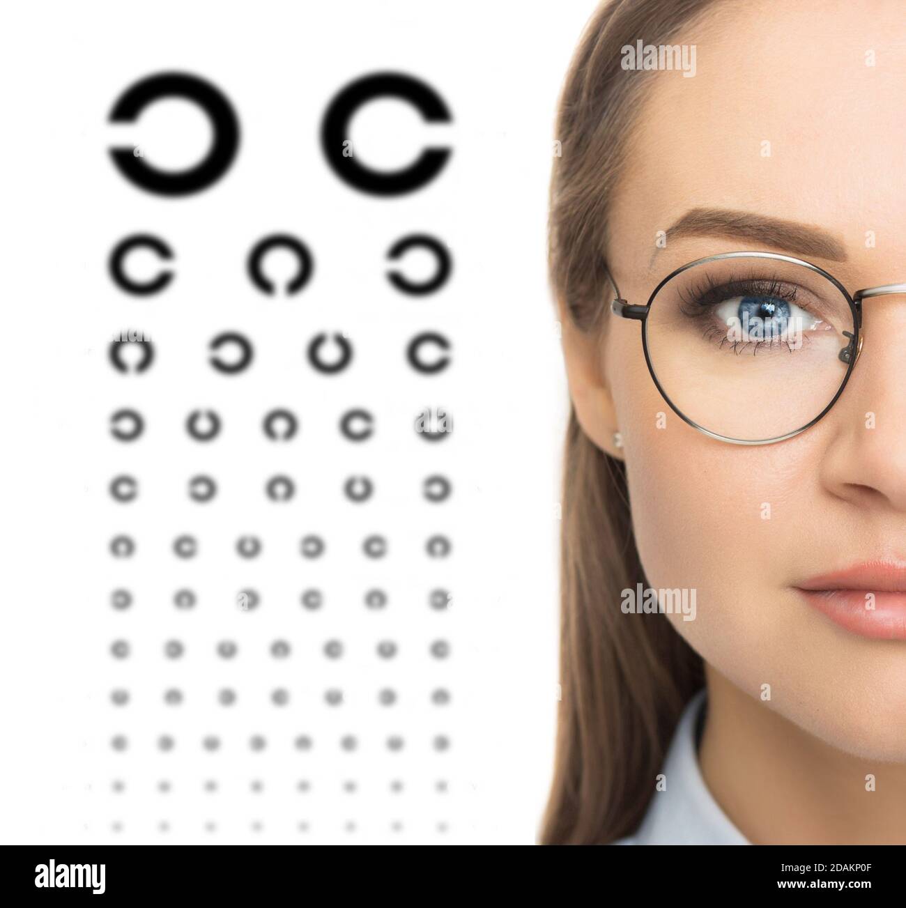 Medicine and vision concept - woman's eyes and eye chart. Stock Photo