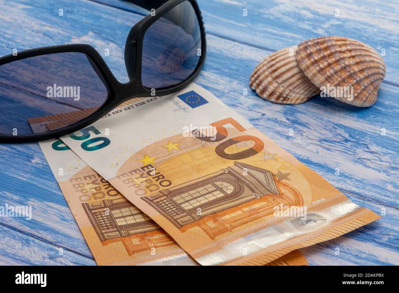 European vacation concept with Euro banknotes, sea shells and sunglasses Stock Photo