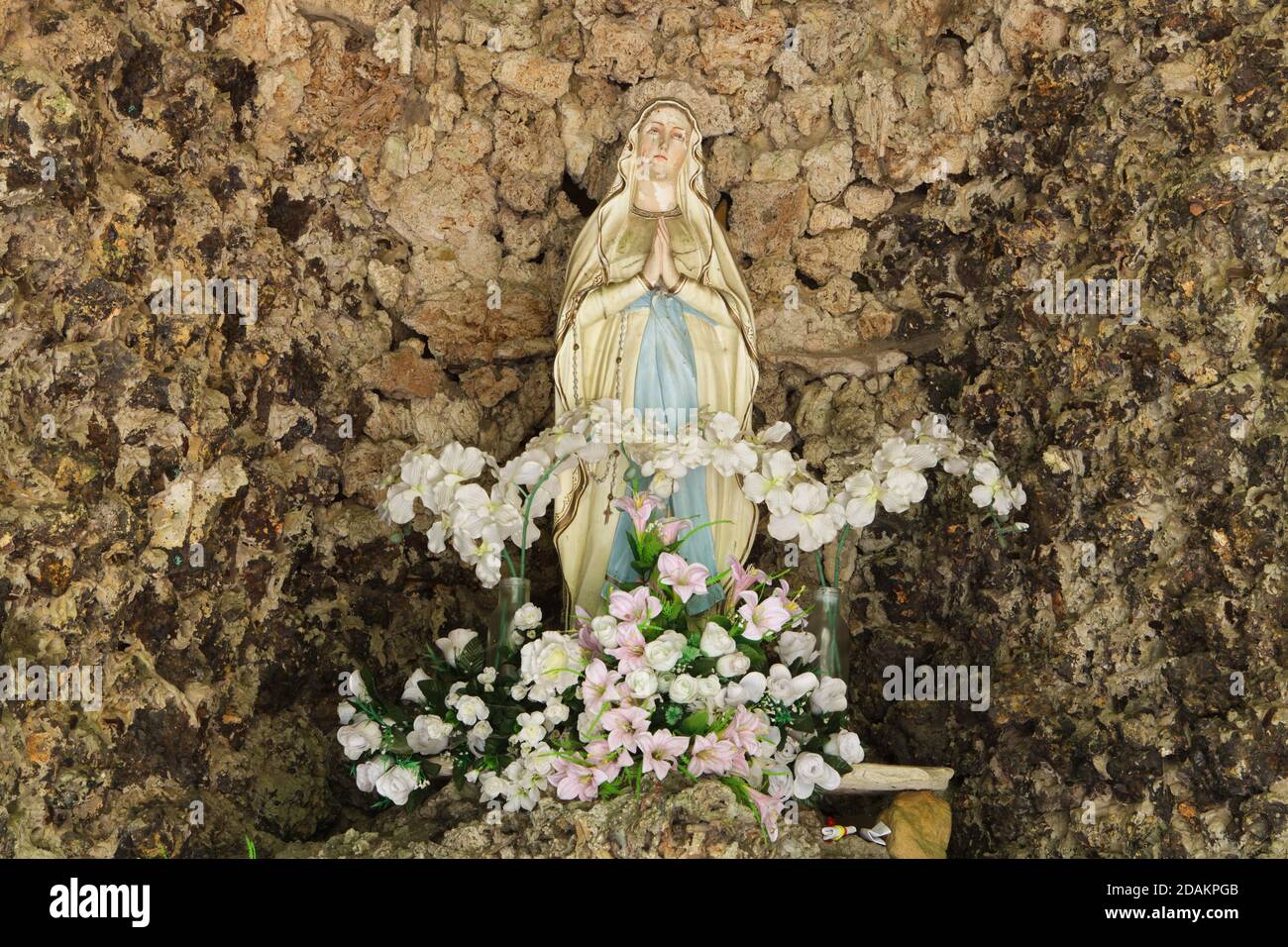 Statue of Our Lady of Lourdes on the main altar in the rock chapel in the Modlivý důl (Praying Valley) near Svojkov in the Lusatian Mountains in North Bohemia, Czech Republic. The rock chapel is devoted to Our Lady of Lourdes. Stock Photo