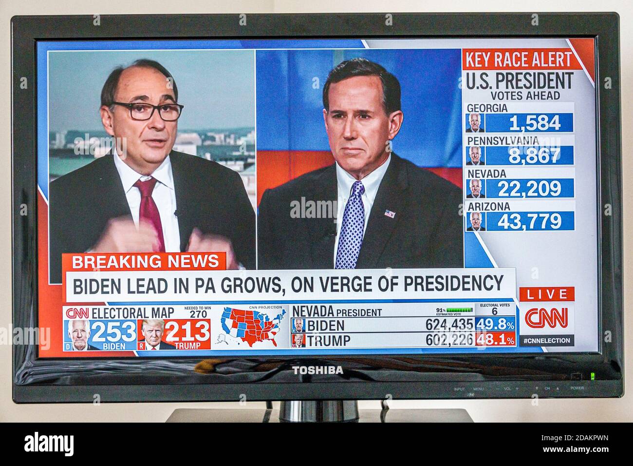TV cable television screen monitor 2020 US presidential election results,Joe Biden Donald Trump votes electoral college popular vote count,takes lead Stock Photo