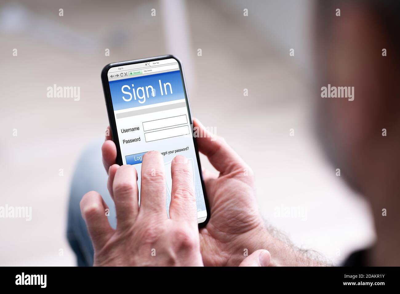 Hand Holding Mobile Phone Or Smartphone With Website Login Stock Photo