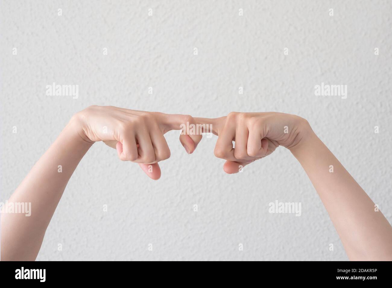 Finger in finger together. Finger lock. Two hands held together by