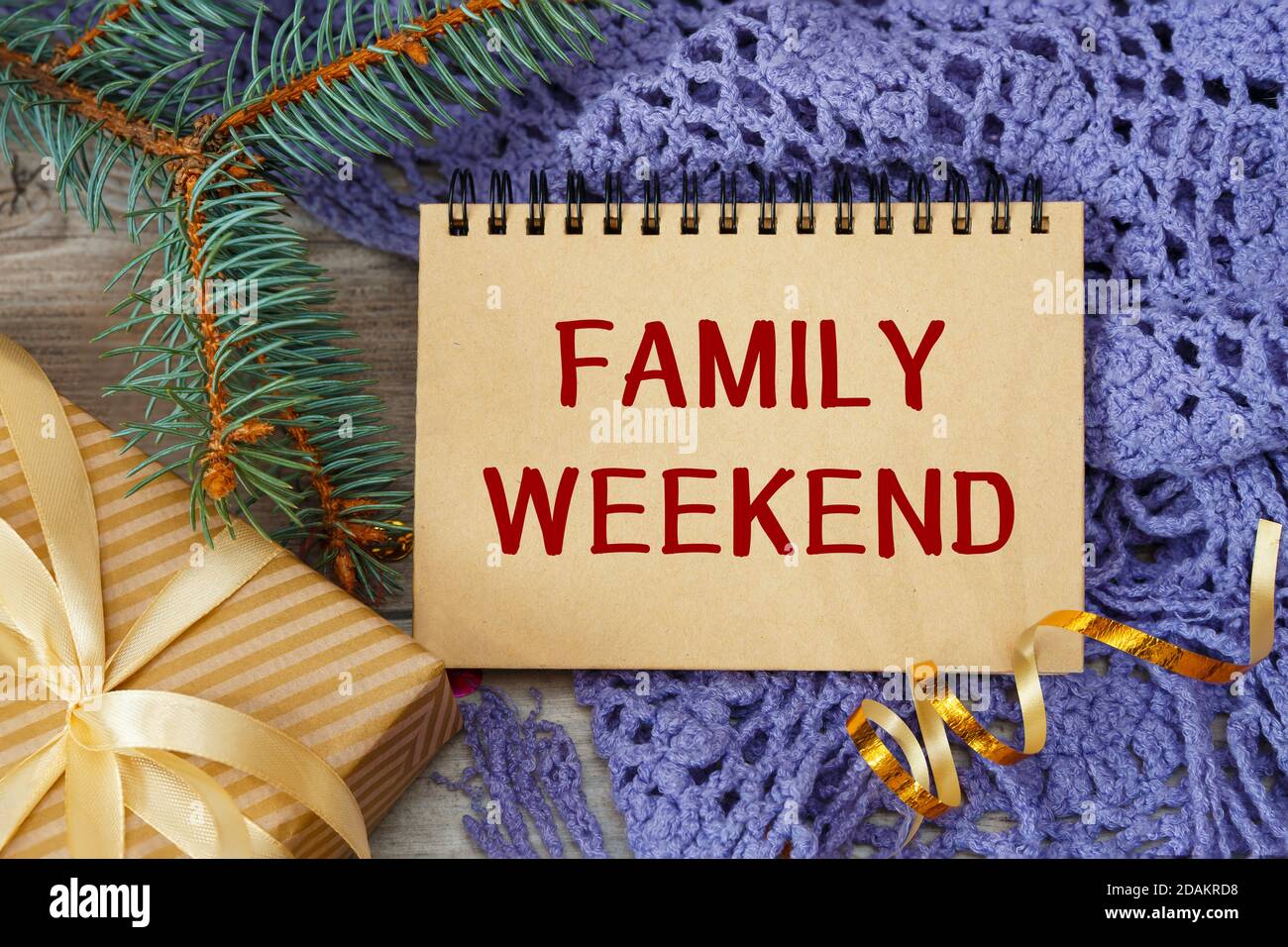 FAMILY WEEKEND - an inscription on a notebook, a scarf and a gift Stock Photo