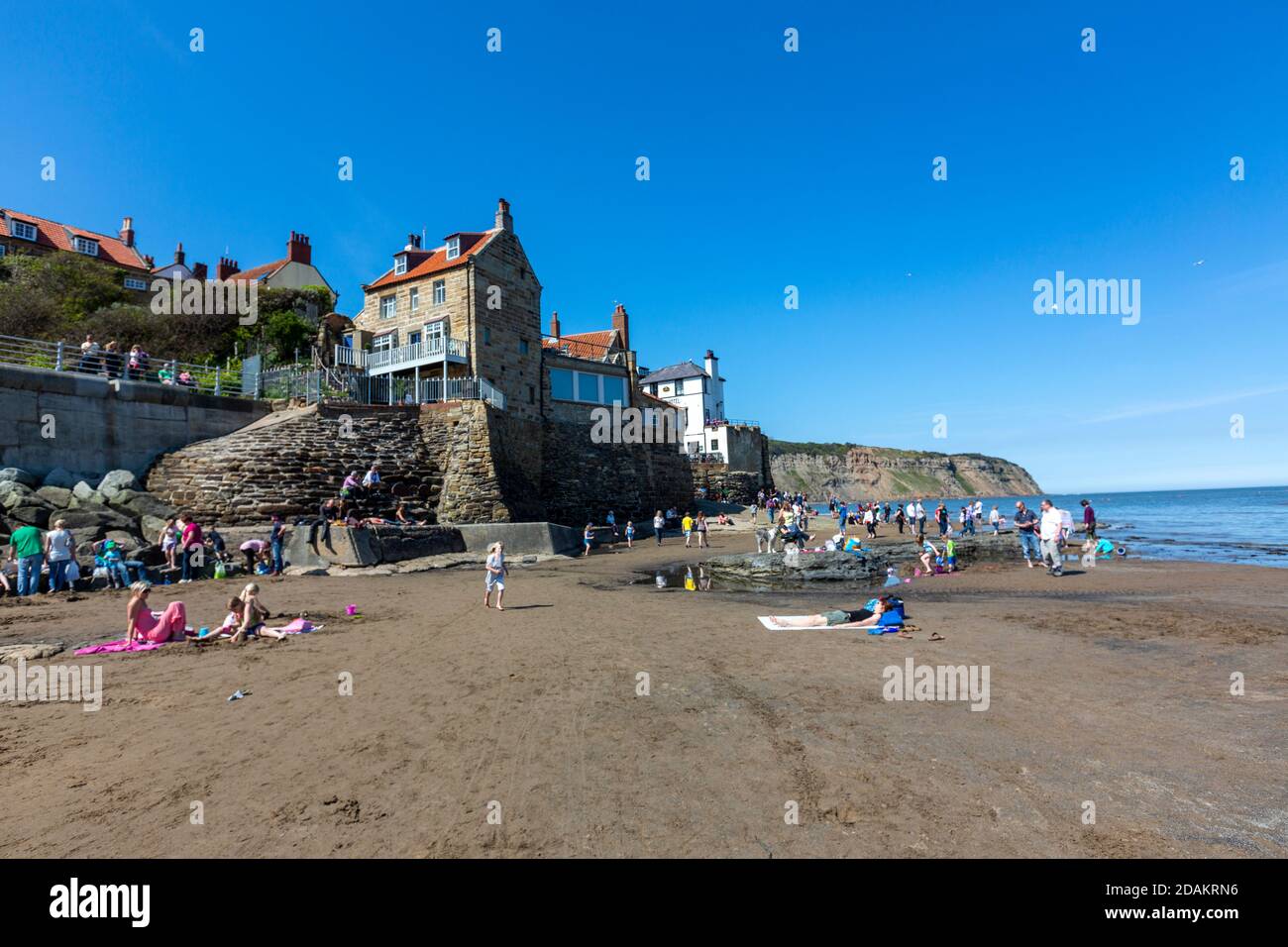 Tourist Enjoying At The Beach In Robin Hood s Bay Small Fishing 