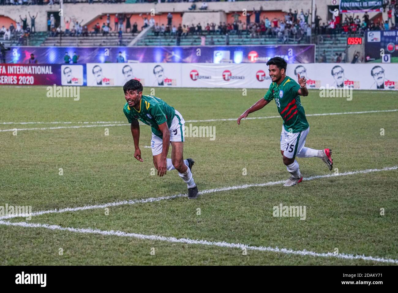 Bangladeshi Mohammad Nabib Newaz Ziban (L) and Sumon Reza (R) celebrate a goal during the First FIFA friendly match between Bangladesh and Nepal at Bangabandhu National Stadium in Dhaka.(Final score; Bangladesh 20