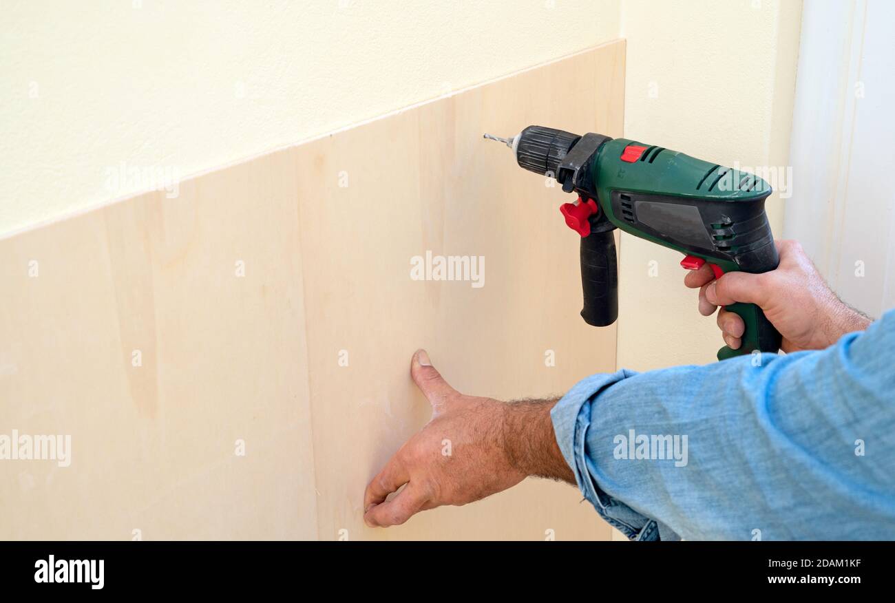 Human hand holding drill machine Stock Photo