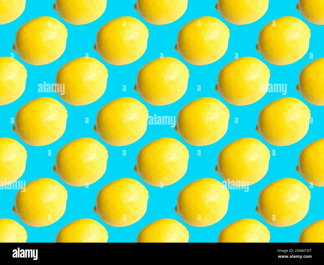 Seamless geometric pattern, lemon on a delicate turquoise background. Stock Photo