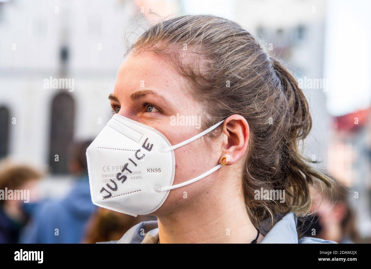 Munich, Bavaria, Germany. 13th Nov, 2020. A Fridays for Future demonstrator has the word ''justice'' written on her mask. Fridays for Future Germany has returned to the streets during the second wave of Coronavirus to protest against the clearing of the DannenrodÂ Forest (DannenrÃ¶derÂ Forst). The demonstrators marched from Marienplatz to the Green Party offices where three protestors climbed a tree a hung a banner which eventually resulted in a police response that was initially peacefully resolved until unidentified plainclothes officers attempted an apprehension without identifying them Stock Photo