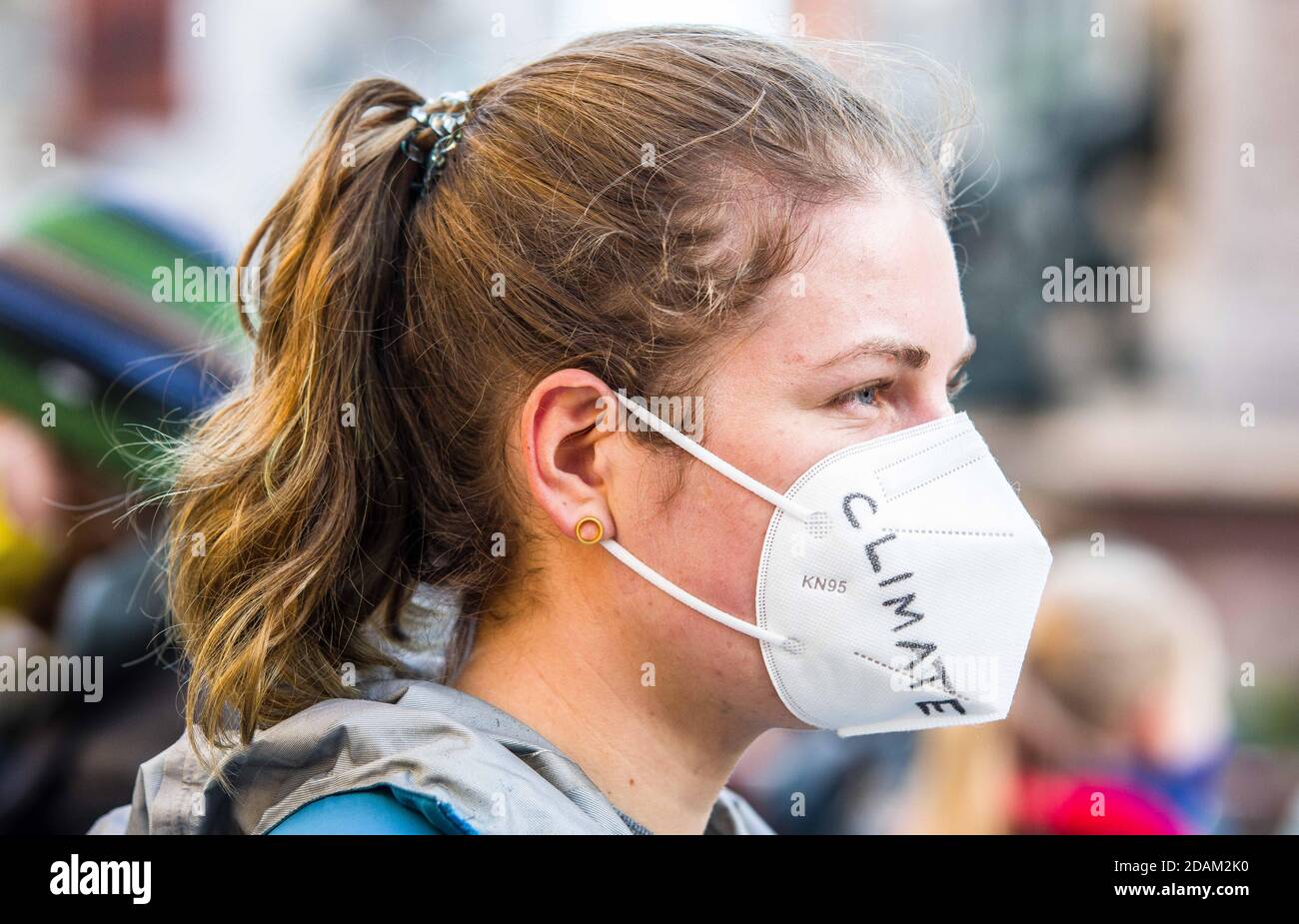 Munich, Bavaria, Germany. 13th Nov, 2020. A Fridays for Future demonstrator has the word ''climate'' written on her mask. Fridays for Future Germany has returned to the streets during the second wave of Coronavirus to protest against the clearing of the DannenrodÂ Forest (DannenrÃ¶derÂ Forst). The demonstrators marched from Marienplatz to the Green Party offices where three protestors climbed a tree a hung a banner which eventually resulted in a police response that was initially peacefully resolved until unidentified plainclothes officers attempted an apprehension without identifying them Stock Photo
