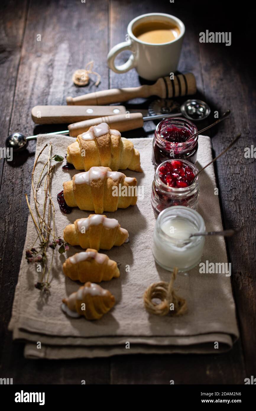 Breakfast croissant and aromatic espresso.Healthy food and drink.Sweet dessert.Wooden table. Stock Photo