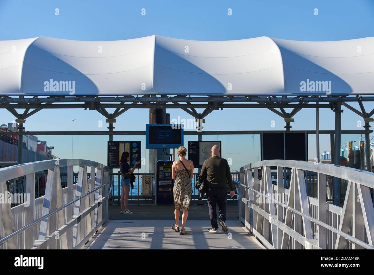 A man and a woman enter the NYC Ferry landing at Atlantic Av in