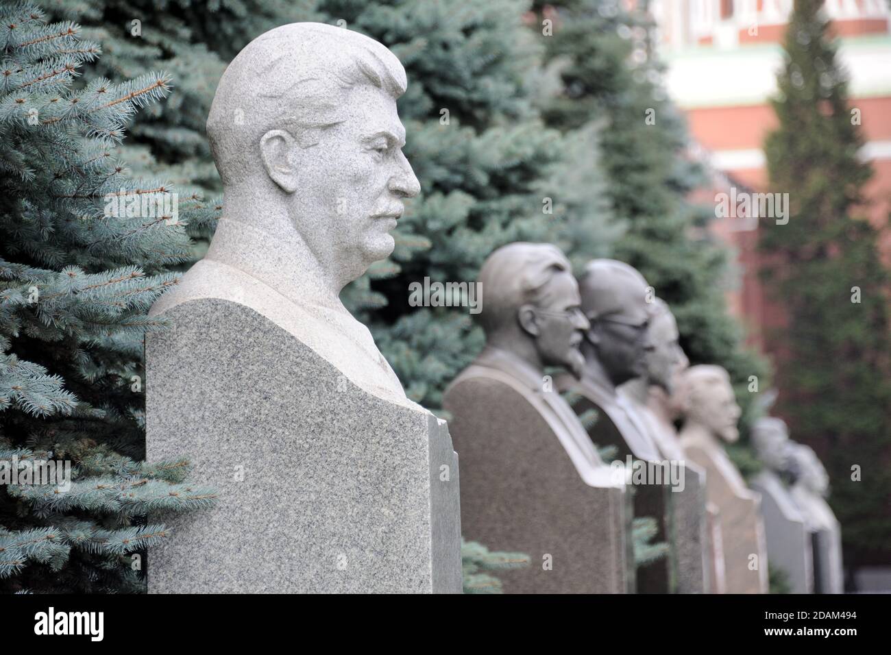 = Stalin and Other Soviet Leaders =  Side angle view on the light grey marble bust of Stalin and other Communist party leaders and renowned military c Stock Photo